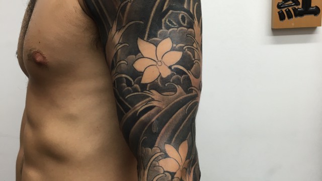 Marc Pinto primitive tattoo Perth Japanese snake, waves and cherry blossom flowers.