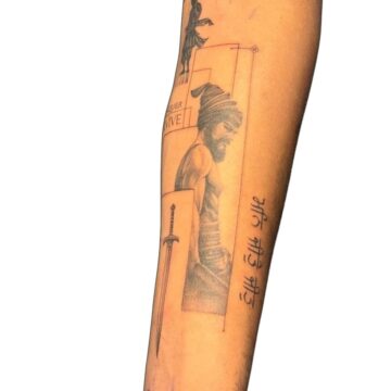Black and grey warrior portrait forearm tattoo with sword and script by Nilyu – Primitive Tattoo Perth